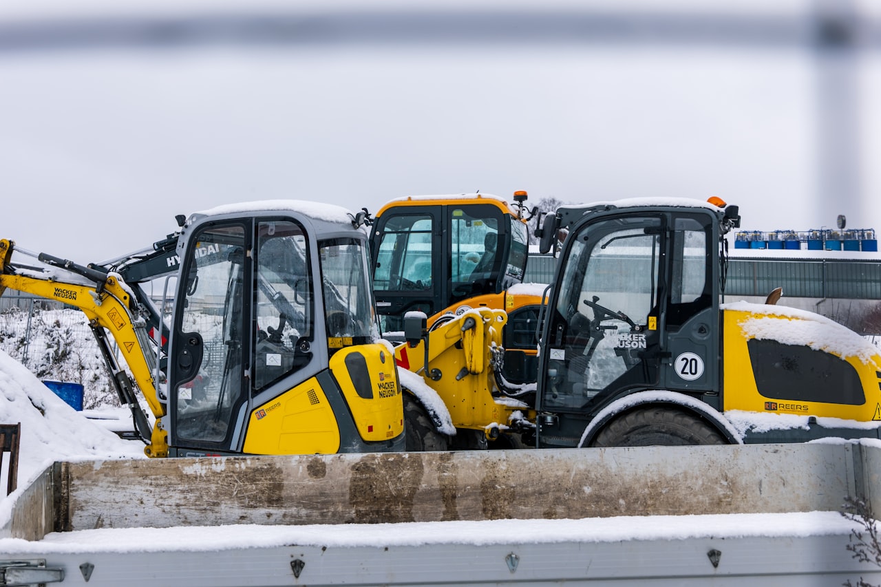 Mini excavator squeezing through a side gate